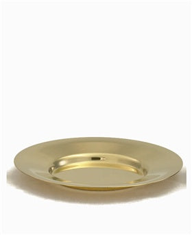 A gold-plated brass paten with a polished finish, used for holding religious items in a church.