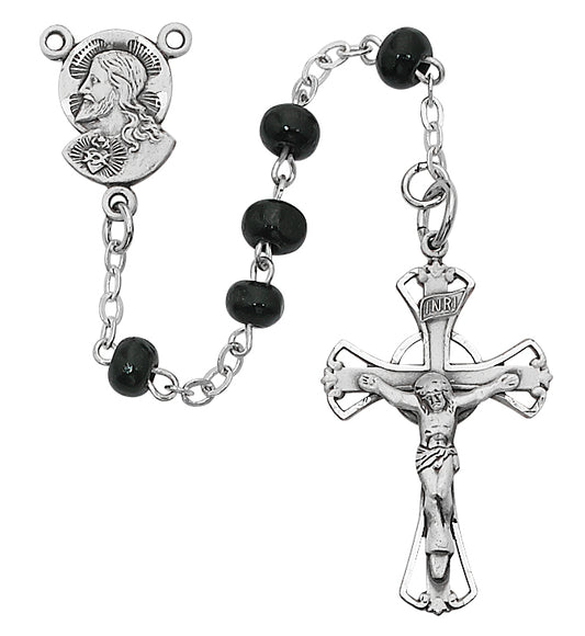 A black wood rosary with silver metallic accents, including a crucifix and a figure of Jesus Christ, displayed against a white background.