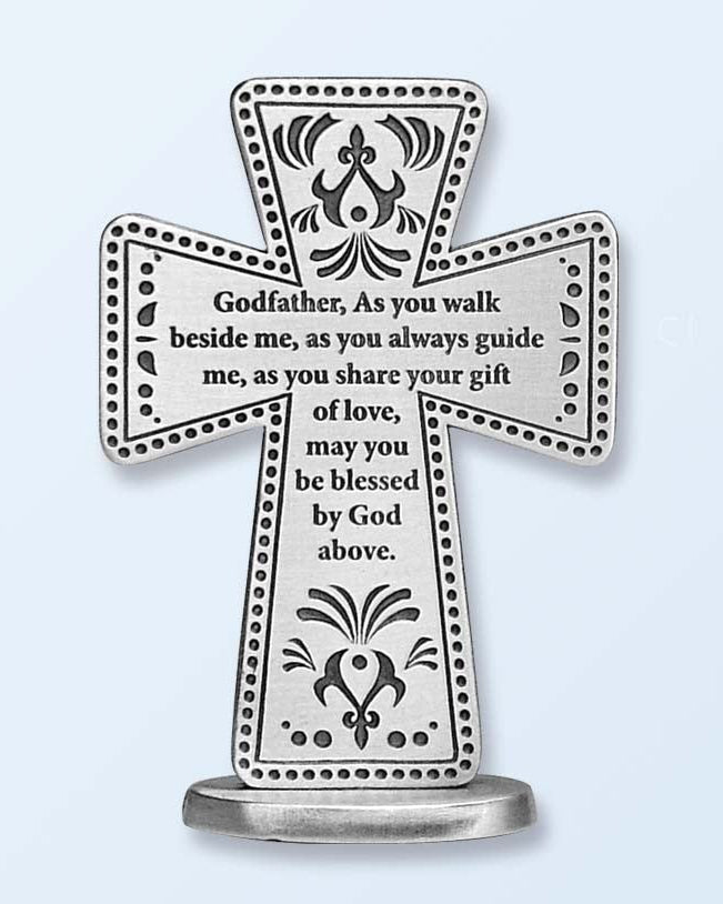 A silver pewter cross with ornate detailing and an inscription for a Godfather. The cross is standing on a base and has a polished finish.