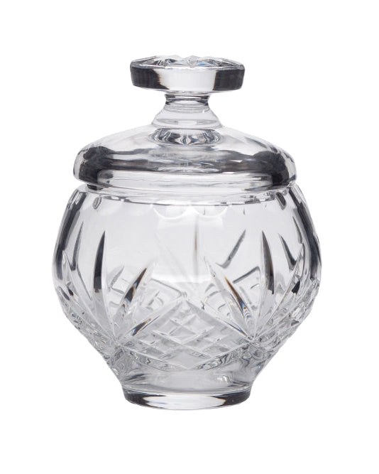 A clear glass ablution cup with a lid, featuring intricate cut glass patterns.