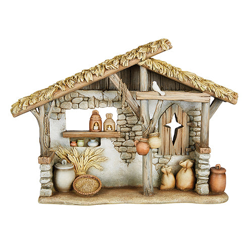 A resin stone mix nativity set featuring a stable with a thatched roof, a donkey, a bird, and some pottery items.