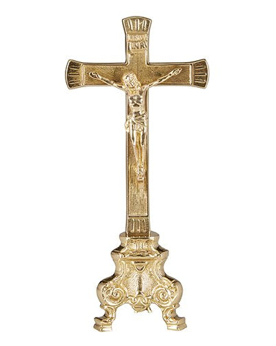 A gold-colored brass crucifix with a pedestal base and silver-plated details.