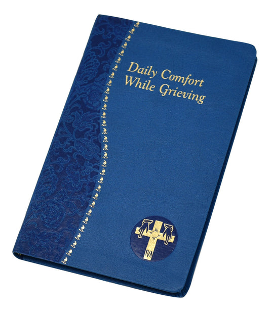 A blue-covered book titled 'Daily Comfort While Grieving' with a golden cross and decorative patterns on the cover.