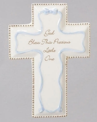 A blue and white porcelain wall cross with the text 'GOD BLESS THIS PRECIOUS LITTLE ONE' written on it.