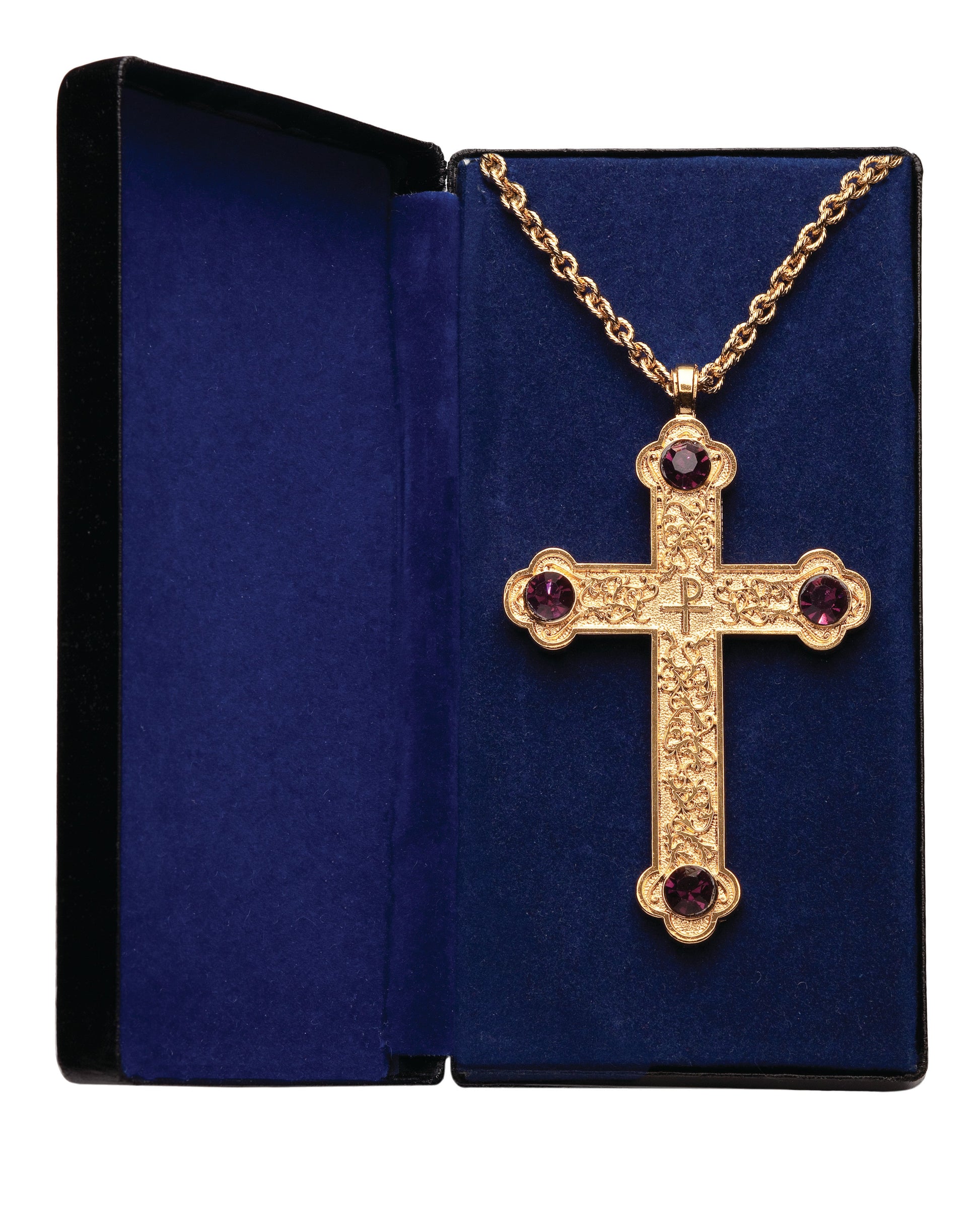 A gold-plated pectoral cross with scroll design and amethyst stones, displayed in a blue gift box.