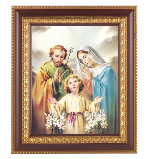 A framed picture of the Holy Family consisting of three individuals, with a cherry wood frame and gold edge, overall dimensions 11x13 inches.