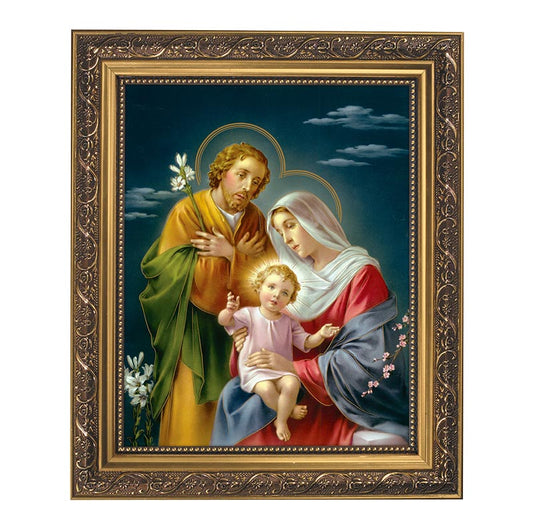 A framed print of the Holy Family with ornate antique gold finish frame, featuring Joseph, Mary, and baby Jesus.
