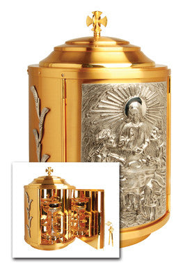 A gold-plated silver tabernacle with accents and an image of Jesus Christ on the front panel. It includes a cross on top and a detailed depiction of an angel on the side.