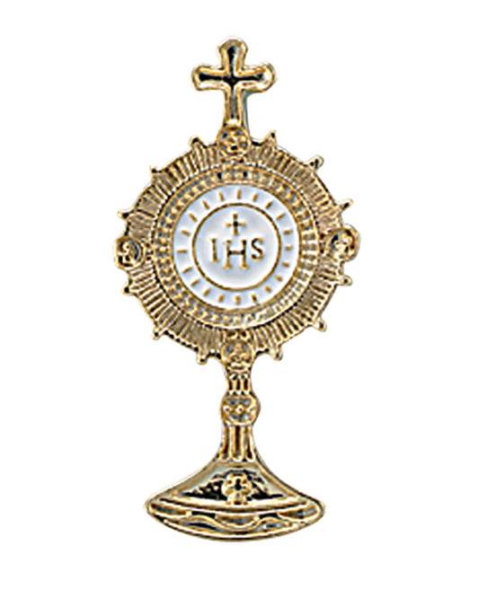 A gold tone lapel pin with an enamel design featuring a cross and the IHS symbol, mounted on a card for presentation.