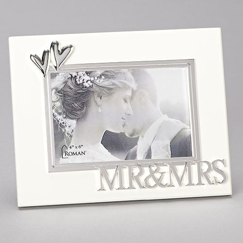 A silver-colored enamelled picture frame with 'MR & MRS' text, holding a 4x6 picture of a couple.