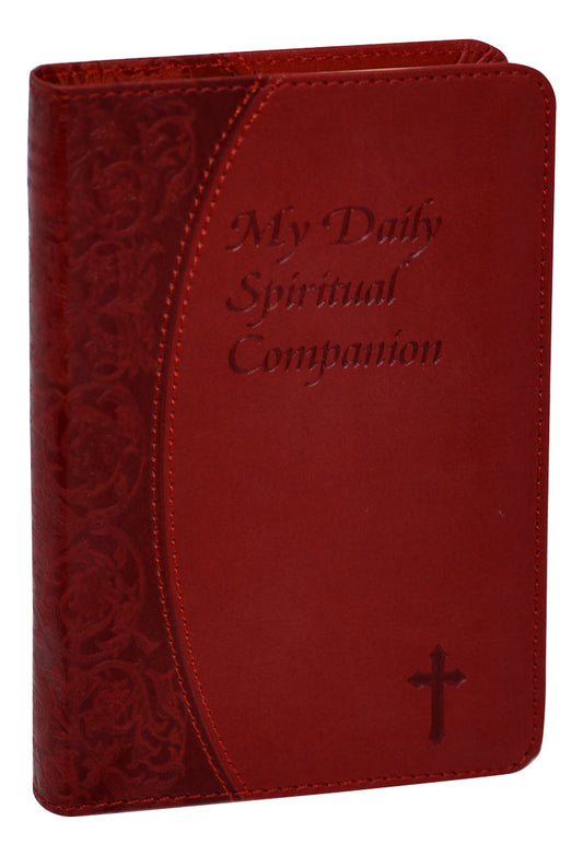 A burgundy leatherette cover of 'My Daily Spiritual Companion' with embossed title and a cross symbol, featuring a satin ribbon for place-keeping.