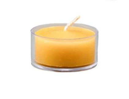A single beeswax tealight candle in a clear cup with a warm glow.