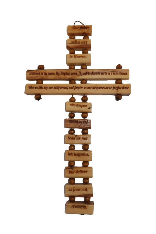 A wall-mounted olive wood cross with 'Our Father' prayer written in various languages.