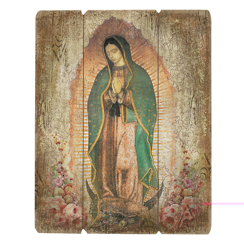 A wooden plaque featuring Our Lady of Guadalupe with a traditional floral design and a green veil.