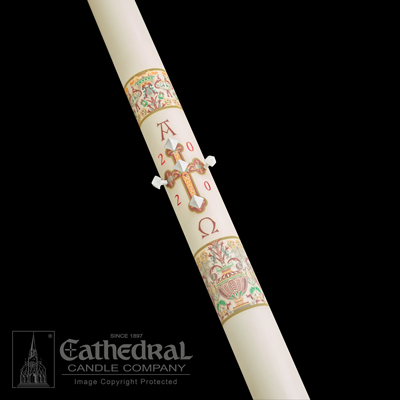 A beige-colored Paschal candle with decorations in gold, green, and red, and the year 2000 inscribed on it, with the Cathedral Candle Company logo at the bottom.