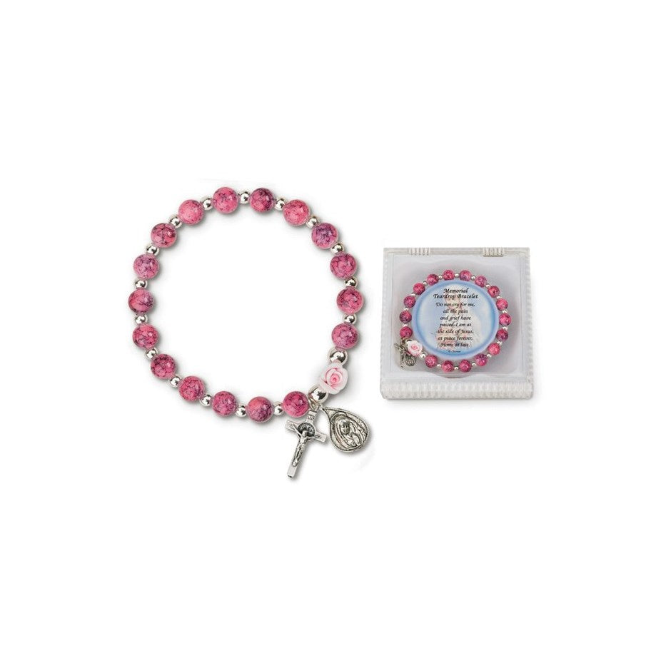 A pink glass memorial teardrop bracelet with a silver-tone clasp, alongside a pink card with a message.