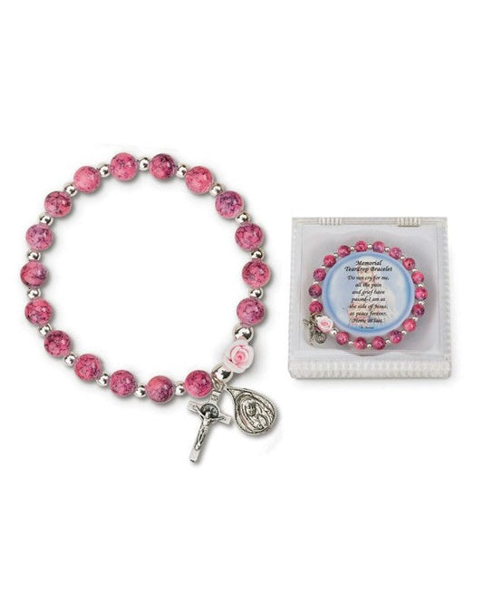 A pink glass memorial teardrop bracelet with a silver-tone clasp, alongside a pink card with a message.