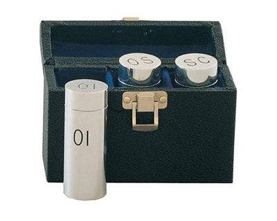 Three aluminum containers with threaded covers inside a black case, labeled OI, OS, SC respectively, for holding sacristy oil.