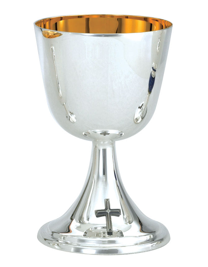 A silver chalice with a gold plated interior and a cross design at the base, standing on a solid pedestal.