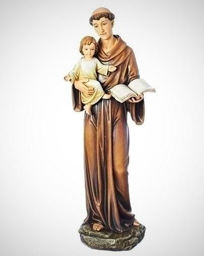 A resin statue of St. Anthony holding a child and a book.