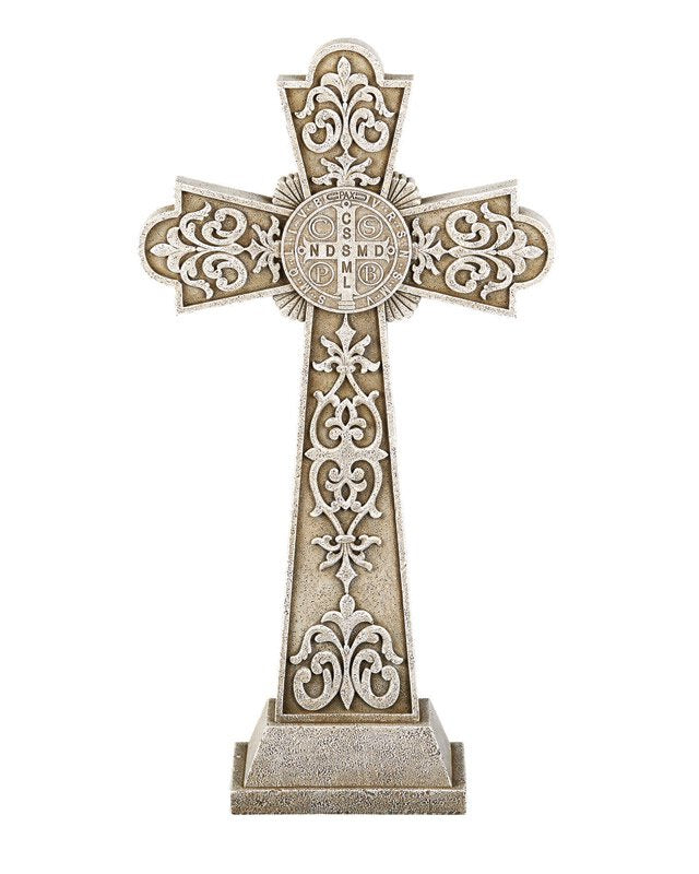 A beige and brown Saint Benedict Garden Cross made of stone resin, featuring intricate designs and the iconic medal with the image of St. Benedict on one side.