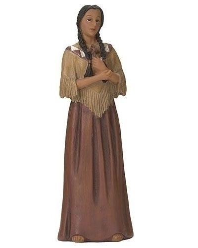A 4-inch statue of Saint Kateri Tekakwitha wearing a traditional garment, standing with her hands clasped in front of her chest.