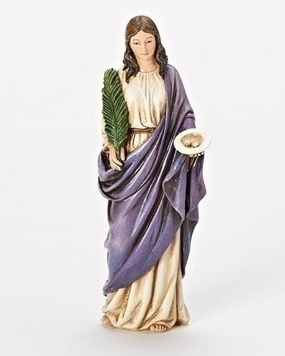 A statue of Saint Lucy holding a dish and a palm frond, wearing a purple and gold robe.