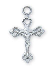 A sterling silver crucifix pendant with intricate detailing, accompanied by a rhodium plated brass chain, displayed against a white background.