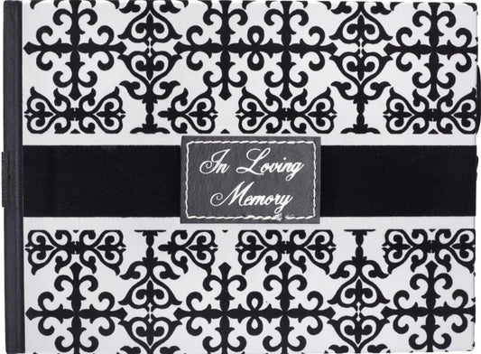 A black and white guest book with a cross design and the title 'In Loving Memory' written on the front cover.