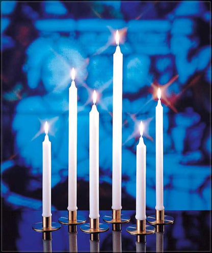 A group of white candles lit, set against a blue background, representing the Stearine Brand White Molded Candles.